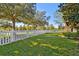 Landscaped front yard with a white picket fence at 21149 Pleasant Plains Pkwy, Land O Lakes, FL 34637