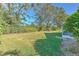 Landscaped backyard with lush lawn and mature trees at 3125 Bent Creek Dr, Valrico, FL 33596