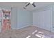Bedroom with double door closet and view of hallway at 3125 Bent Creek Dr, Valrico, FL 33596