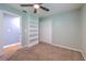 Spacious bedroom with built-in shelving and plush carpeting at 3125 Bent Creek Dr, Valrico, FL 33596