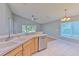Bright kitchen with light wood cabinets, stainless steel appliances, and a double sink at 3125 Bent Creek Dr, Valrico, FL 33596