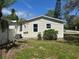 Spacious backyard with new siding, green grass, and lush foliage, ideal for outdoor activities at 3562 Fisher Rd, Palm Harbor, FL 34683