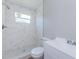 This bathroom offers a shower with marble tiling, a new toilet, and a sink with storage at 3562 Fisher Rd, Palm Harbor, FL 34683