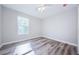 Spacious bedroom with wood-look floors and large window at 3562 Fisher Rd, Palm Harbor, FL 34683