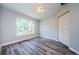 Bright bedroom with wood-look flooring and closet at 3562 Fisher Rd, Palm Harbor, FL 34683