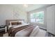 Cozy bedroom boasts an updated look with stylish furnishings and natural light at 3562 Fisher Rd, Palm Harbor, FL 34683