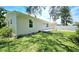 Exterior view of the home showcasing the back yard and the side yard at 3562 Fisher Rd, Palm Harbor, FL 34683