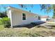 Newly renovated exterior showing siding, a front porch, and windows under a clear blue sky at 3562 Fisher Rd, Palm Harbor, FL 34683