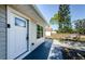 Inviting front entry with white door and decorative glass accents at 3562 Fisher Rd, Palm Harbor, FL 34683