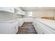Open kitchen featuring new white cabinets, light countertops, and modern flooring at 3562 Fisher Rd, Palm Harbor, FL 34683