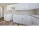 Modern kitchen with granite countertops, white cabinets, and stainless steel hardware at 3562 Fisher Rd, Palm Harbor, FL 34683