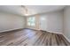 Empty living room features new flooring, trim, and a window, providing natural light at 3562 Fisher Rd, Palm Harbor, FL 34683