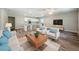 Open-concept living room featuring stylish furniture, a ceiling fan, and an eat-in kitchen at 3562 Fisher Rd, Palm Harbor, FL 34683