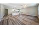 Open living area with wood-look flooring and kitchen island at 3562 Fisher Rd, Palm Harbor, FL 34683