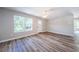 Spacious living room with large window, new flooring, and freshly painted walls at 3562 Fisher Rd, Palm Harbor, FL 34683