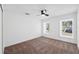 Bright bedroom featuring two windows and a ceiling fan at 3819 Scovill Ln, Valrico, FL 33596