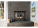 Modern black brick fireplace with glass doors at 3819 Scovill Ln, Valrico, FL 33596