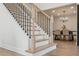 Modern staircase with black metal balusters and light wood steps at 3819 Scovill Ln, Valrico, FL 33596