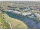 Aerial view of the community with a pond, golf course, and swimming pool surrounded by lush landscaping at 4452 Weybridge St # 74, Sarasota, FL 34235