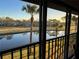 Serene view from the screened balcony, showcasing palm trees and a peaceful pond, creating a relaxing retreat at 4452 Weybridge St # 74, Sarasota, FL 34235