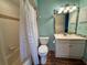 Cozy bathroom with modern vanity, toilet and shower/tub combo with decorative curtain at 4452 Weybridge St # 74, Sarasota, FL 34235