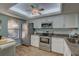 Bright kitchen with stainless steel appliances, white cabinets, and granite countertops at 4452 Weybridge St # 74, Sarasota, FL 34235