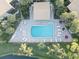 Aerial view of community pool with surrounding lounge chairs and patio at 4452 Weybridge St # 74, Sarasota, FL 34235