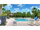 Community swimming pool with plenty of lounge chairs at 4956 Rolling Green Dr, Wesley Chapel, FL 33543