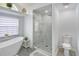 Modern bathroom featuring a walk-in shower with marble tile and a separate toilet at 5112 Teather St, Spring Hill, FL 34608