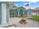 Front entrance with columns, potted plants and a bench at 5112 Teather St, Spring Hill, FL 34608