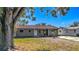 Newly painted house with a well-maintained lawn and mature tree at 5128 49Th N Ave, St Petersburg, FL 33709