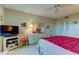 Bedroom with red comforter, ceiling fan, and ample closet space at 7050 Sunset S Dr # 405, South Pasadena, FL 33707