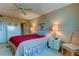 Bedroom with red bedding and ceiling fan, showcasing ample space at 7050 Sunset S Dr # 405, South Pasadena, FL 33707