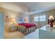 Spacious bedroom with a red comforter, ceiling fan, and built-in dresser at 7050 Sunset S Dr # 405, South Pasadena, FL 33707
