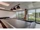 Pool table in a game room with large windows at 7050 Sunset S Dr # 405, South Pasadena, FL 33707
