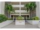 Front entrance of Chateau Tower 7050, featuring landscaping and building name at 7050 Sunset S Dr # 405, South Pasadena, FL 33707