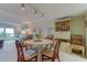 Round dining table with four chairs, situated near living room and bookcase at 7050 Sunset S Dr # 405, South Pasadena, FL 33707