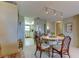 Dining area with a round table and chairs, adjacent to the kitchen at 7050 Sunset S Dr # 405, South Pasadena, FL 33707