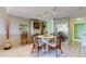 Bright dining area with round table and four chairs, offering a view of the kitchen at 7050 Sunset S Dr # 405, South Pasadena, FL 33707