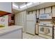 Well-equipped kitchen featuring white appliances and ample counter space at 7050 Sunset S Dr # 405, South Pasadena, FL 33707
