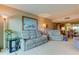 Open living space with gray couches, a large window, and views at 7050 Sunset S Dr # 405, South Pasadena, FL 33707