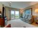 Bright living room with large windows, leather couches and water views at 7050 Sunset S Dr # 405, South Pasadena, FL 33707