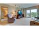 Living room with bay window, recliner chair and access to balcony at 7050 Sunset S Dr # 405, South Pasadena, FL 33707