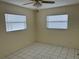 Cozy bedroom featuring neutral walls, tile flooring, and two large windows with blinds at 10170 64Th Ave, Seminole, FL 33772