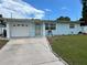 Charming single-story home with a well-manicured lawn, garage, and inviting front entrance at 10170 64Th Ave, Seminole, FL 33772