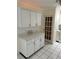 Efficient kitchen featuring white cabinets, quartz countertops, and tiled floors at 10170 64Th Ave, Seminole, FL 33772