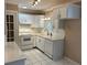 White kitchen cabinets, quartz countertops, and tile floors at 10170 64Th Ave, Seminole, FL 33772