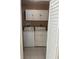 A laundry room featuring a washer, dryer, and overhead cabinets at 10170 64Th Ave, Seminole, FL 33772