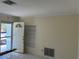 Inviting living room featuring tile flooring, a built-in shelving unit, and an open doorway at 10170 64Th Ave, Seminole, FL 33772