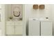 Bright laundry room with washer, dryer, and cabinets at 10876 Ibis Brook Ct, Land O Lakes, FL 34638